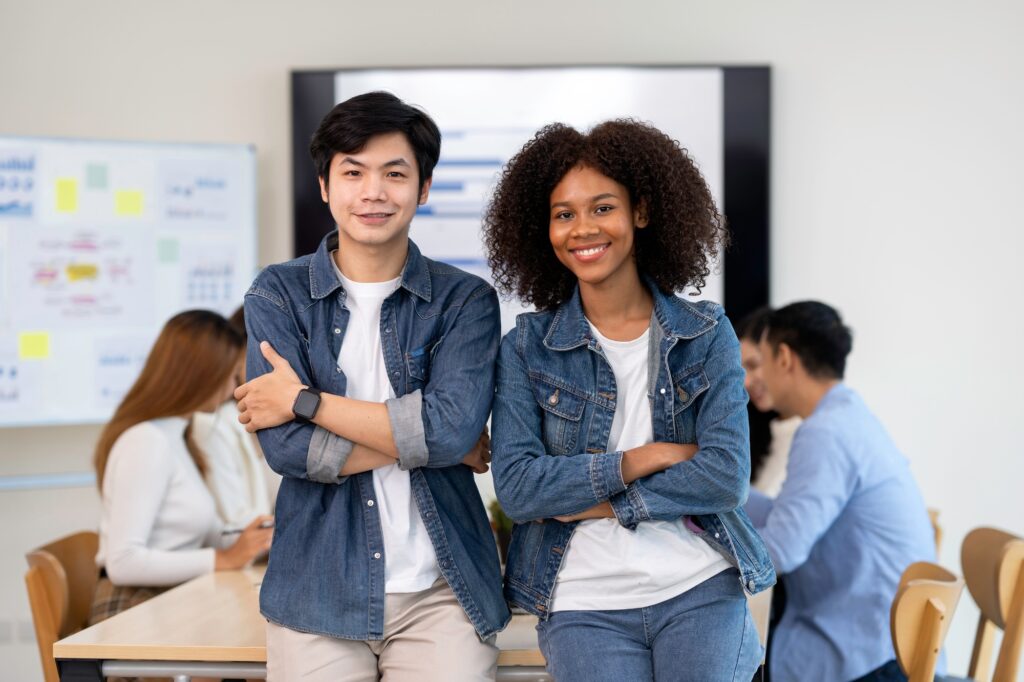 African American office woman standing with a colleague in the office